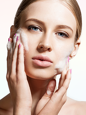Woman with Touch glycolic acid face wash foam on her face