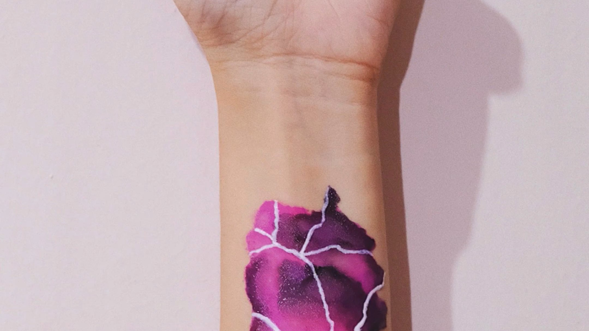 Watercolor tattoo using water activated liners!  What do you see – flowers 🌸 or lightning 🌩?  (DIY black light using scotch tape + blue and purple markers)